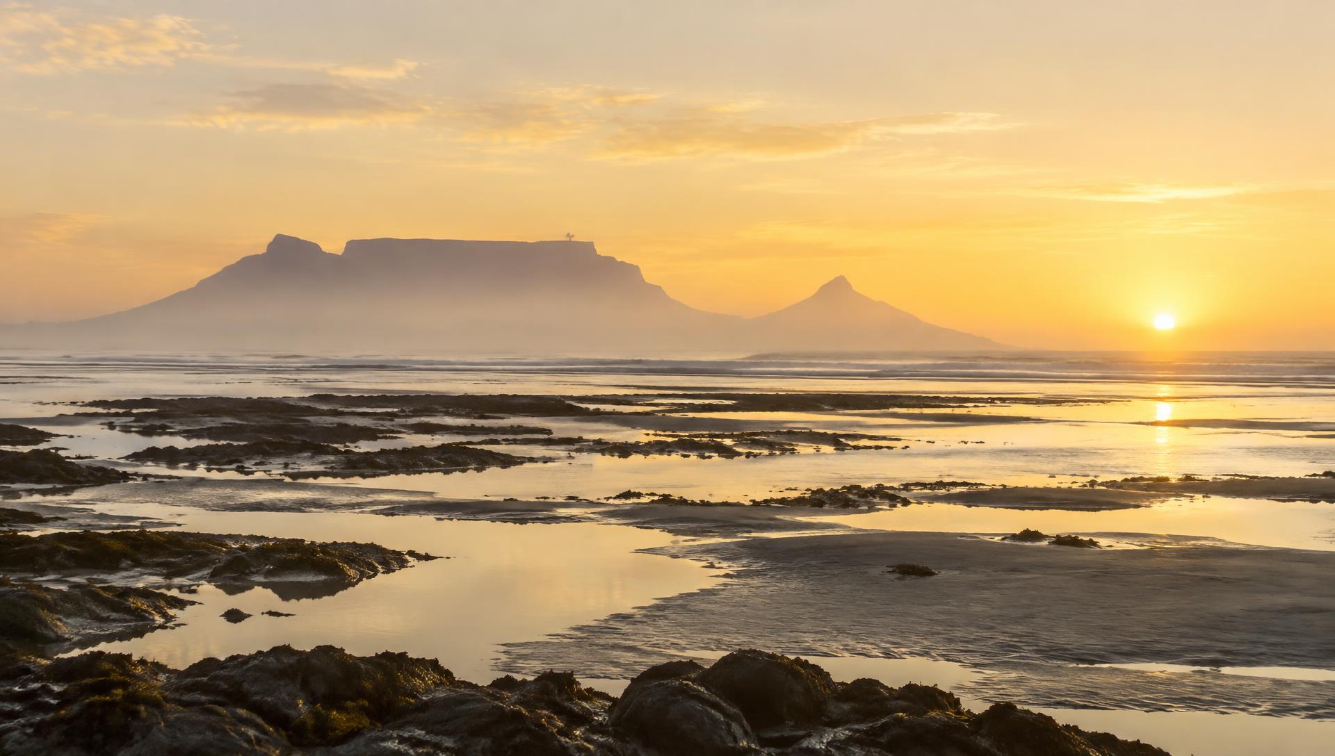 Soft dawn light over still coastal waters in the Western Cape